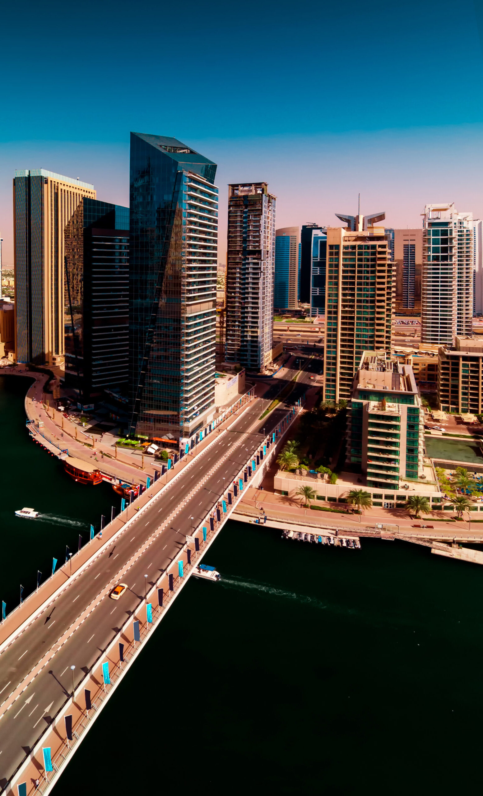 Amazing colorful dubai marina skyline with water canal during sunny day, Dubai, United Arab Emirates.